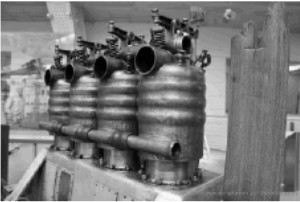 Four cylinders and the wooden mast on the right
